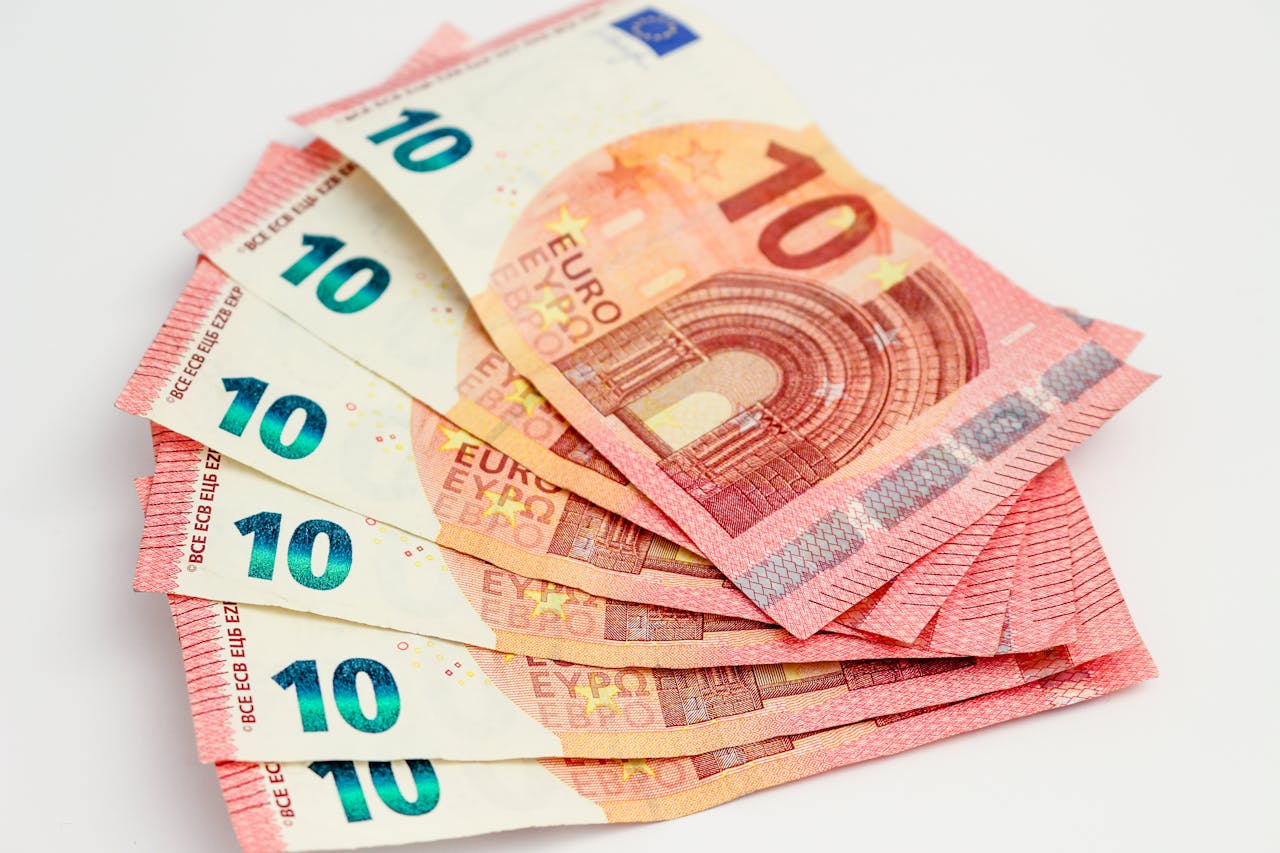 Close-up of a fan of 10 euro banknotes on a clean white background, showcasing European currency.